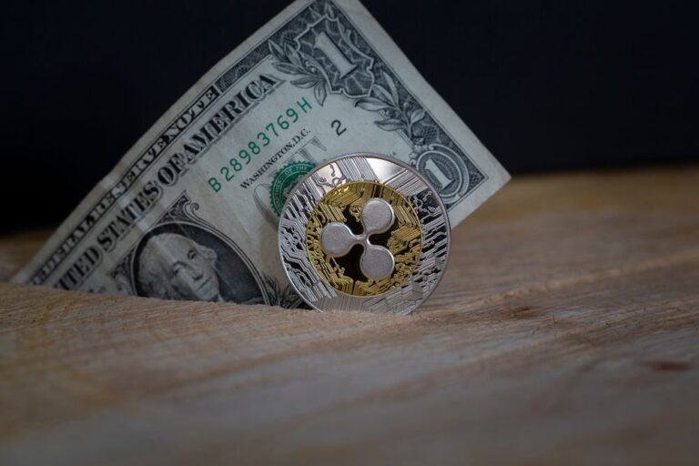 Eine physische XRP-Münze liegt auf einem beleuchteten Kurs-Chart, der Netzwerkaktivität symbolisiert